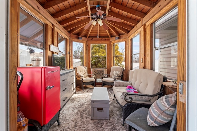 sunroom / solarium featuring ceiling fan, wood ceiling, and beamed ceiling