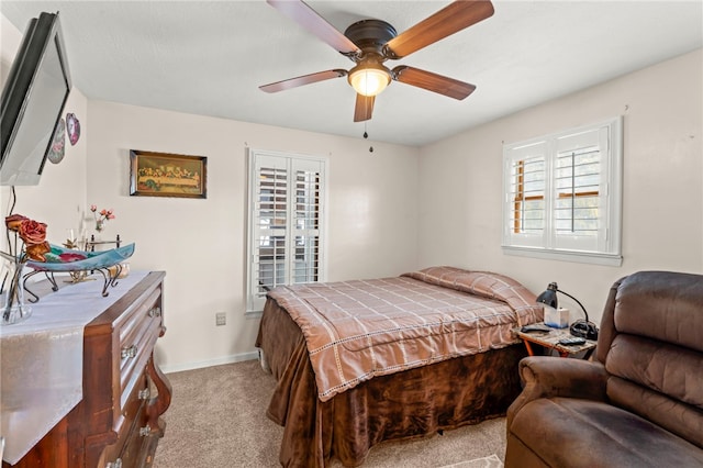 bedroom with ceiling fan and light carpet