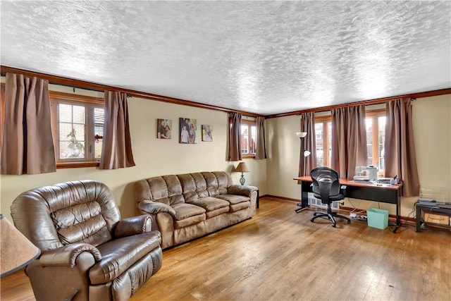 living room featuring light wood-type flooring and ornamental molding