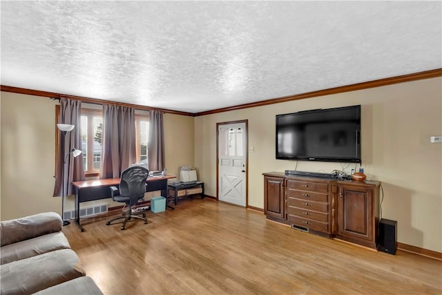 living room with a textured ceiling, crown molding, and light wood-type flooring