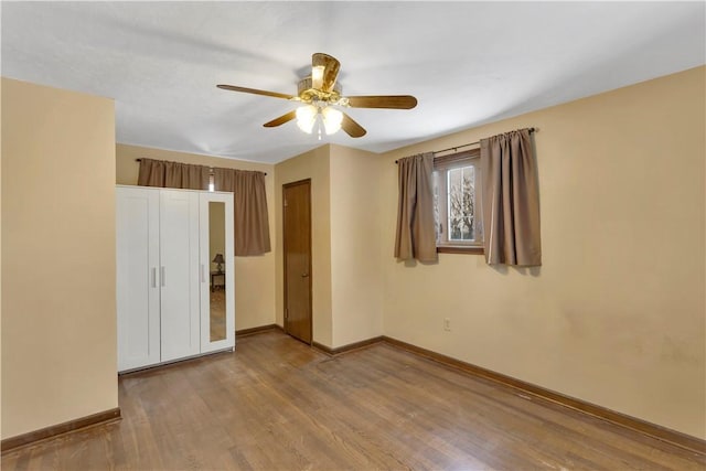 empty room featuring ceiling fan and hardwood / wood-style floors