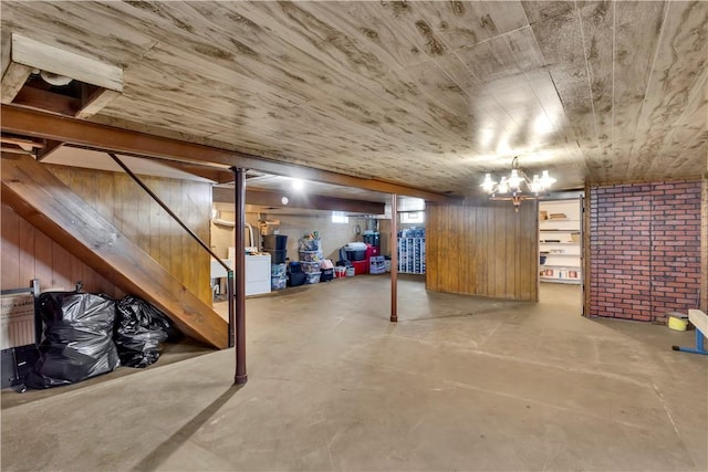 basement with wood ceiling, wood walls, and washer / clothes dryer