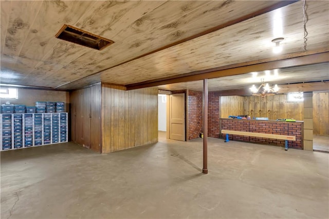 basement with brick wall and wood walls