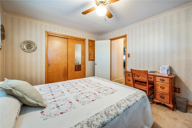 carpeted bedroom with ceiling fan and a closet