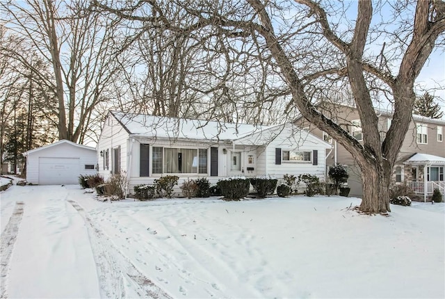 single story home featuring a garage and an outbuilding