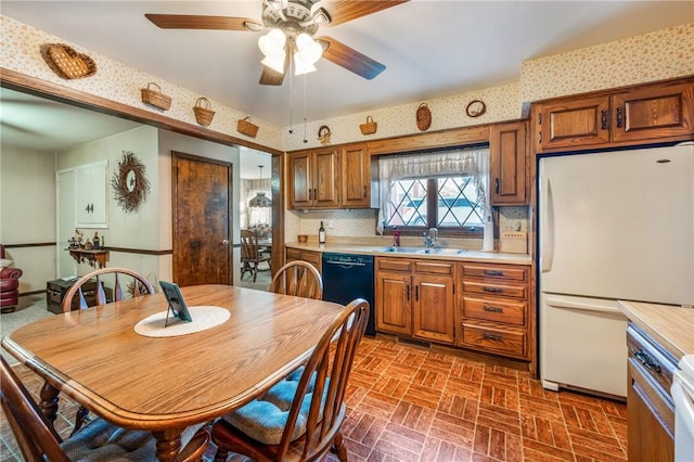 kitchen featuring white fridge, ceiling fan, black dishwasher, and sink