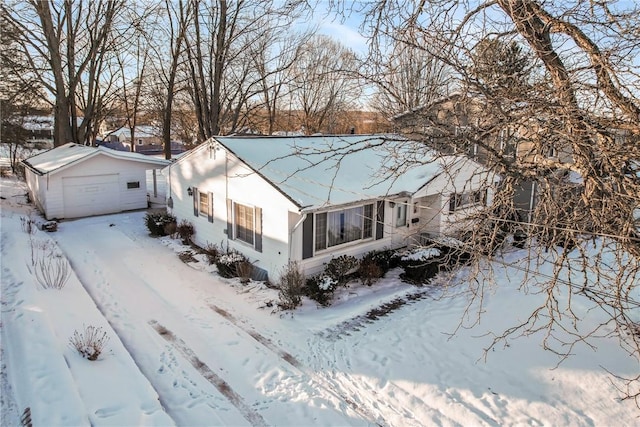 view of front of house featuring a garage and an outdoor structure