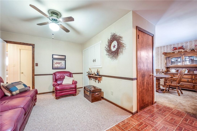 living room featuring ceiling fan and carpet