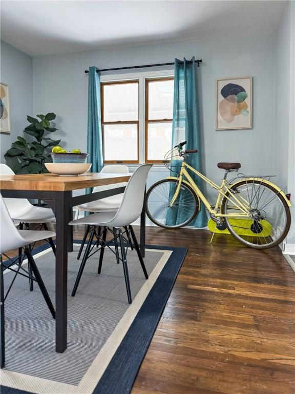 dining area with dark wood-type flooring