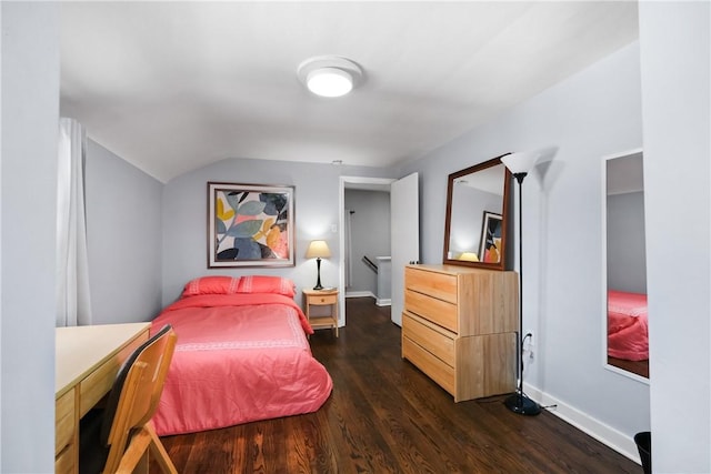 bedroom with lofted ceiling and dark hardwood / wood-style flooring