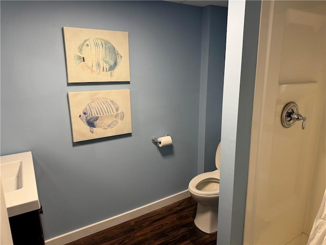 bathroom featuring hardwood / wood-style floors, vanity, and toilet