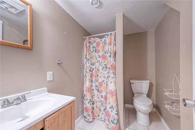 bathroom featuring toilet, tile patterned flooring, walk in shower, and vanity