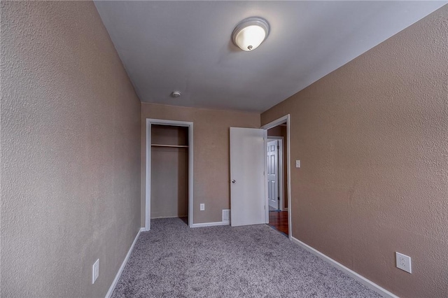 unfurnished bedroom with carpet floors and a closet