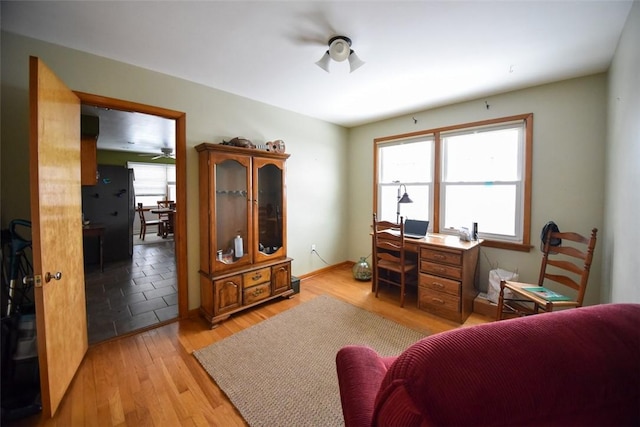 home office featuring ceiling fan and light wood-type flooring