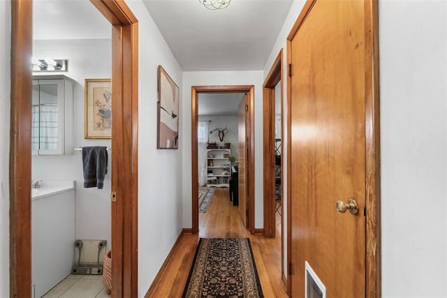 hall with light hardwood / wood-style flooring