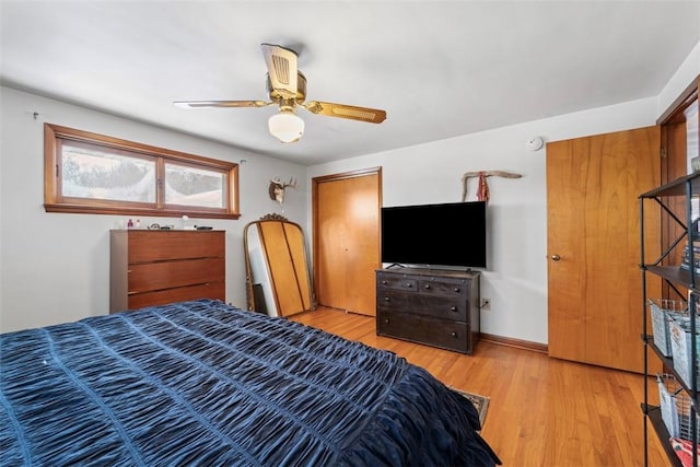 bedroom featuring ceiling fan, a closet, and hardwood / wood-style floors