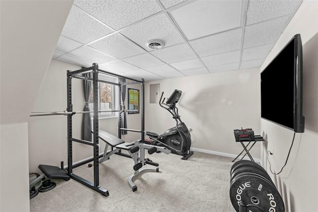 workout area with a paneled ceiling and carpet flooring