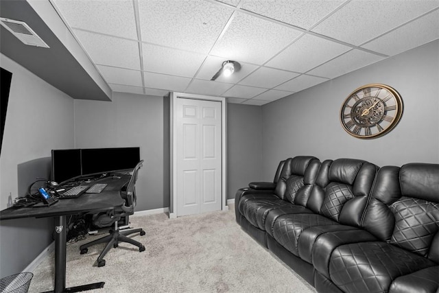 carpeted home office with a drop ceiling