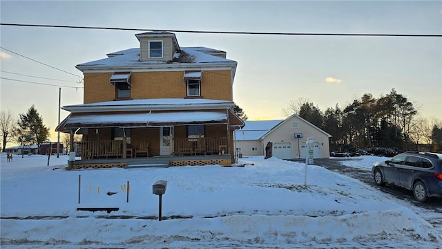 view of front of property with a porch and a garage