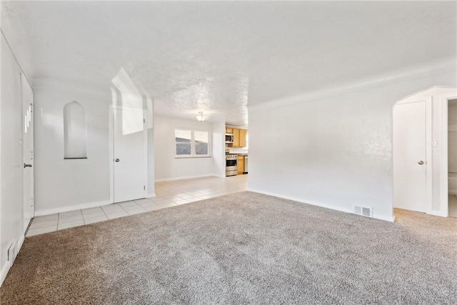 unfurnished living room with light colored carpet