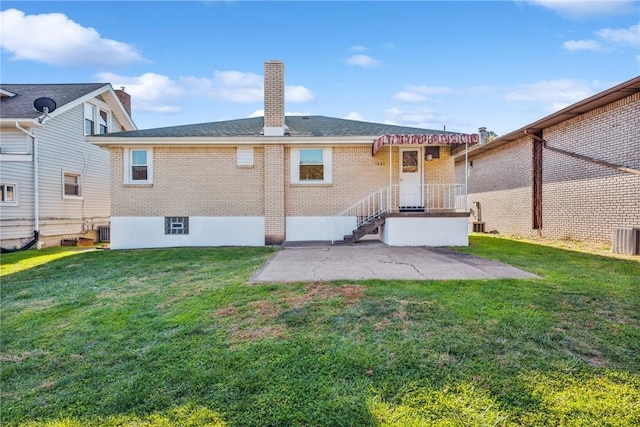 back of property featuring a patio area and a yard