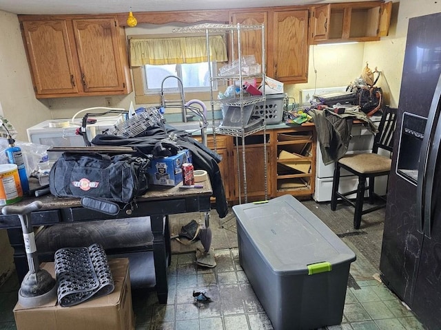 kitchen featuring black refrigerator with ice dispenser