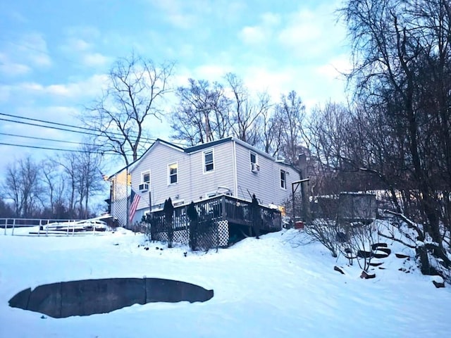 view of snow covered exterior featuring a deck