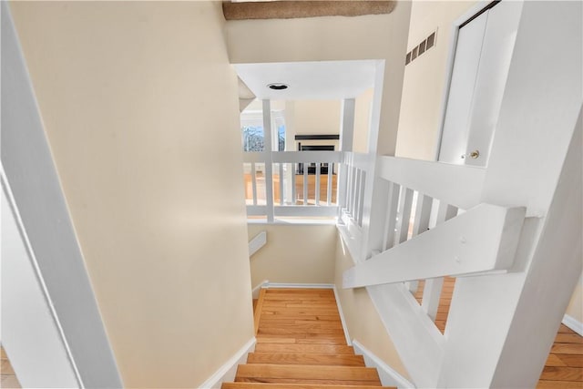 staircase with wood-type flooring