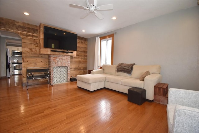 living room featuring wood-type flooring and ceiling fan