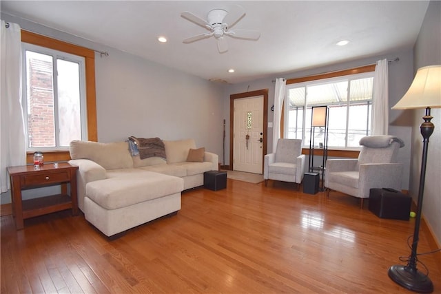 living room with hardwood / wood-style floors and ceiling fan