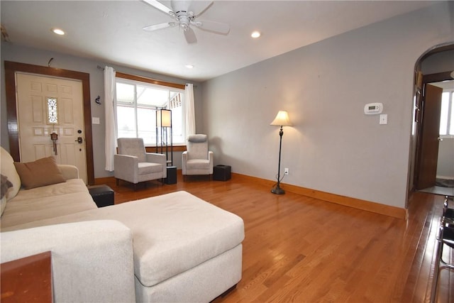 living room featuring ceiling fan and hardwood / wood-style floors