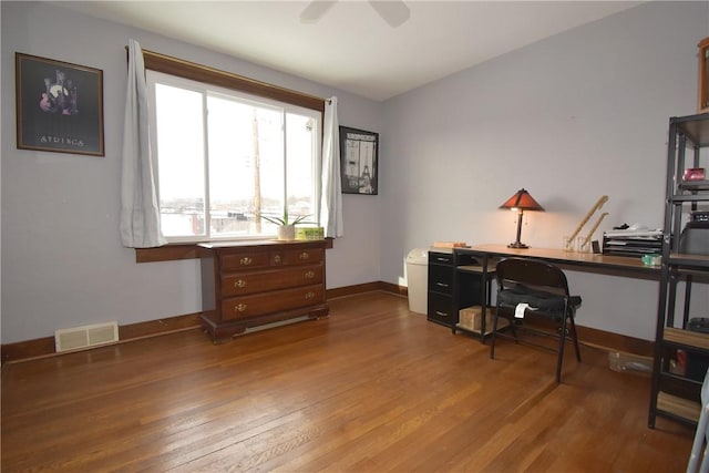 home office featuring hardwood / wood-style floors and ceiling fan