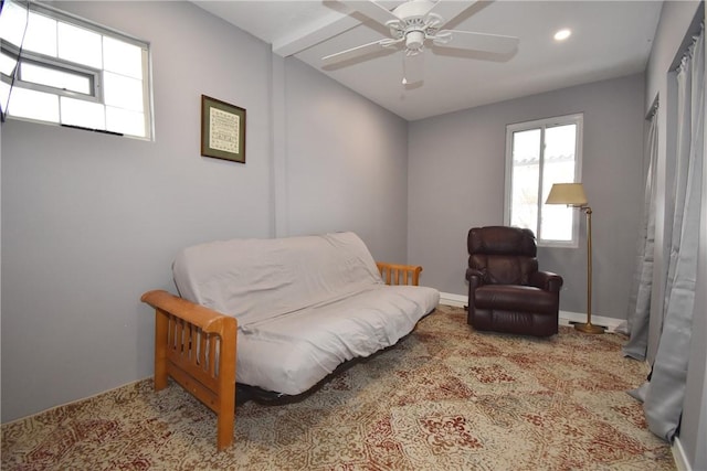 living area with light carpet and ceiling fan