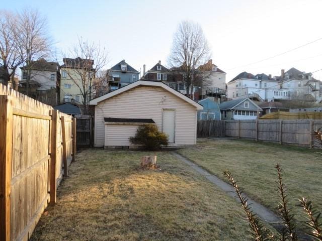 view of side of property with a residential view, a fenced backyard, and a yard