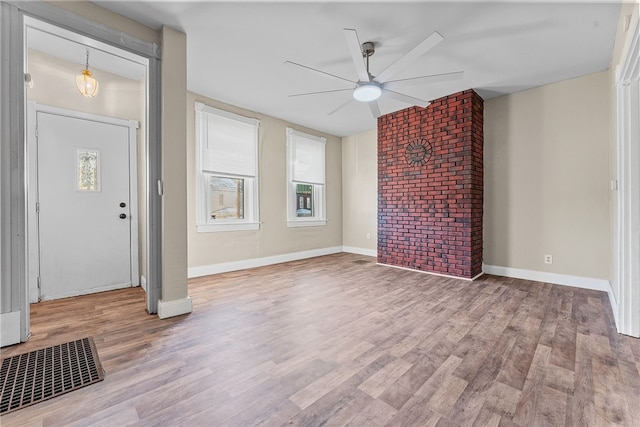 unfurnished living room with ceiling fan and wood-type flooring