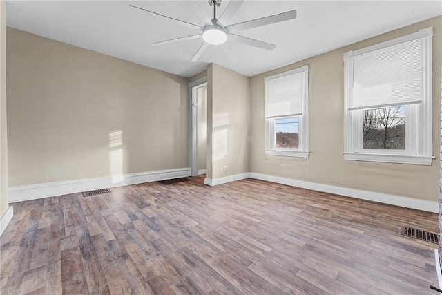 spare room with ceiling fan and wood-type flooring