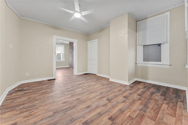 spare room with ornamental molding, ceiling fan, and hardwood / wood-style floors