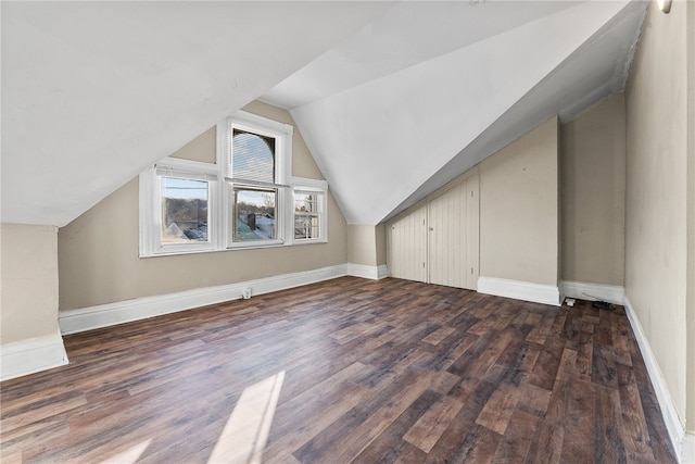 bonus room featuring vaulted ceiling and dark hardwood / wood-style floors