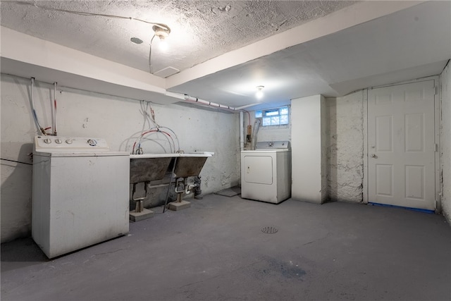 basement with sink and washer and clothes dryer