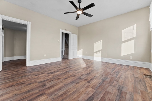 interior space with dark wood-type flooring and ceiling fan