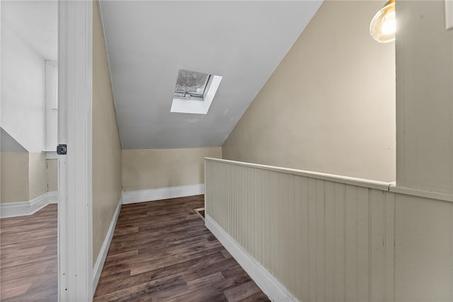 additional living space with lofted ceiling with skylight and dark hardwood / wood-style flooring