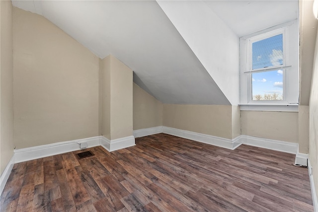 bonus room featuring dark wood-type flooring and lofted ceiling