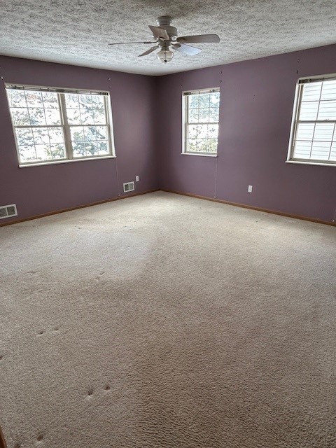 unfurnished room featuring ceiling fan and carpet floors