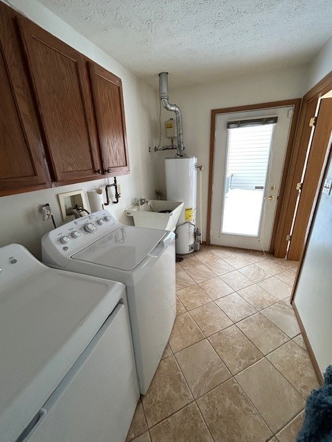 clothes washing area featuring gas water heater, sink, independent washer and dryer, cabinets, and a textured ceiling