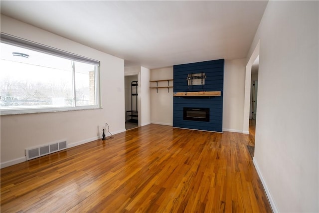 unfurnished living room featuring hardwood / wood-style floors and a fireplace