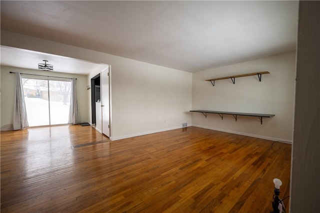 unfurnished living room with hardwood / wood-style floors