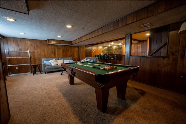 rec room with wood walls, billiards, carpet flooring, and a textured ceiling