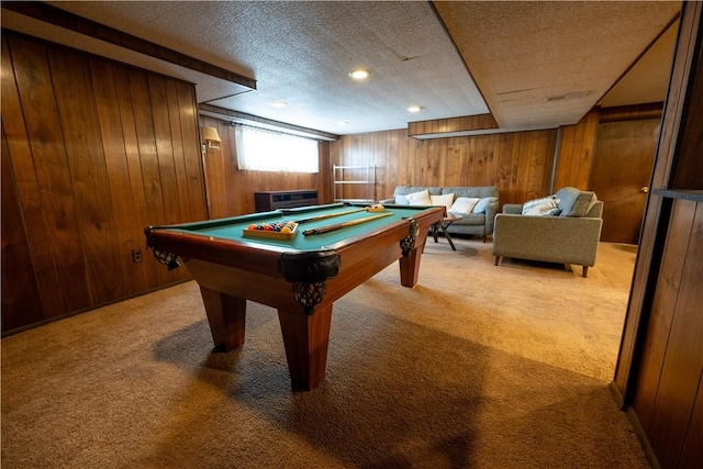 game room with light carpet, wood walls, a textured ceiling, and billiards