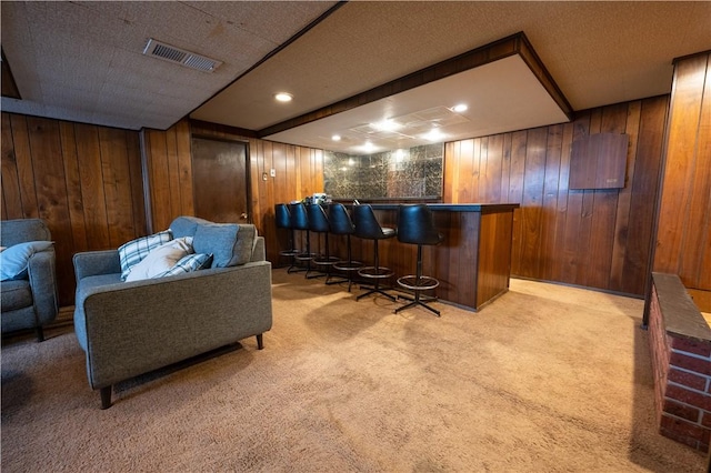 bar with wood walls and light colored carpet