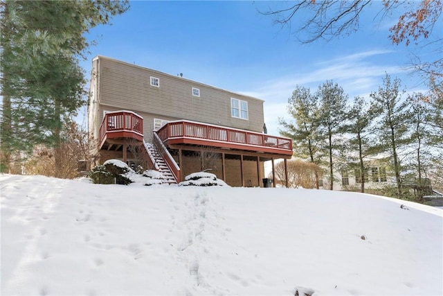 snow covered property featuring a deck